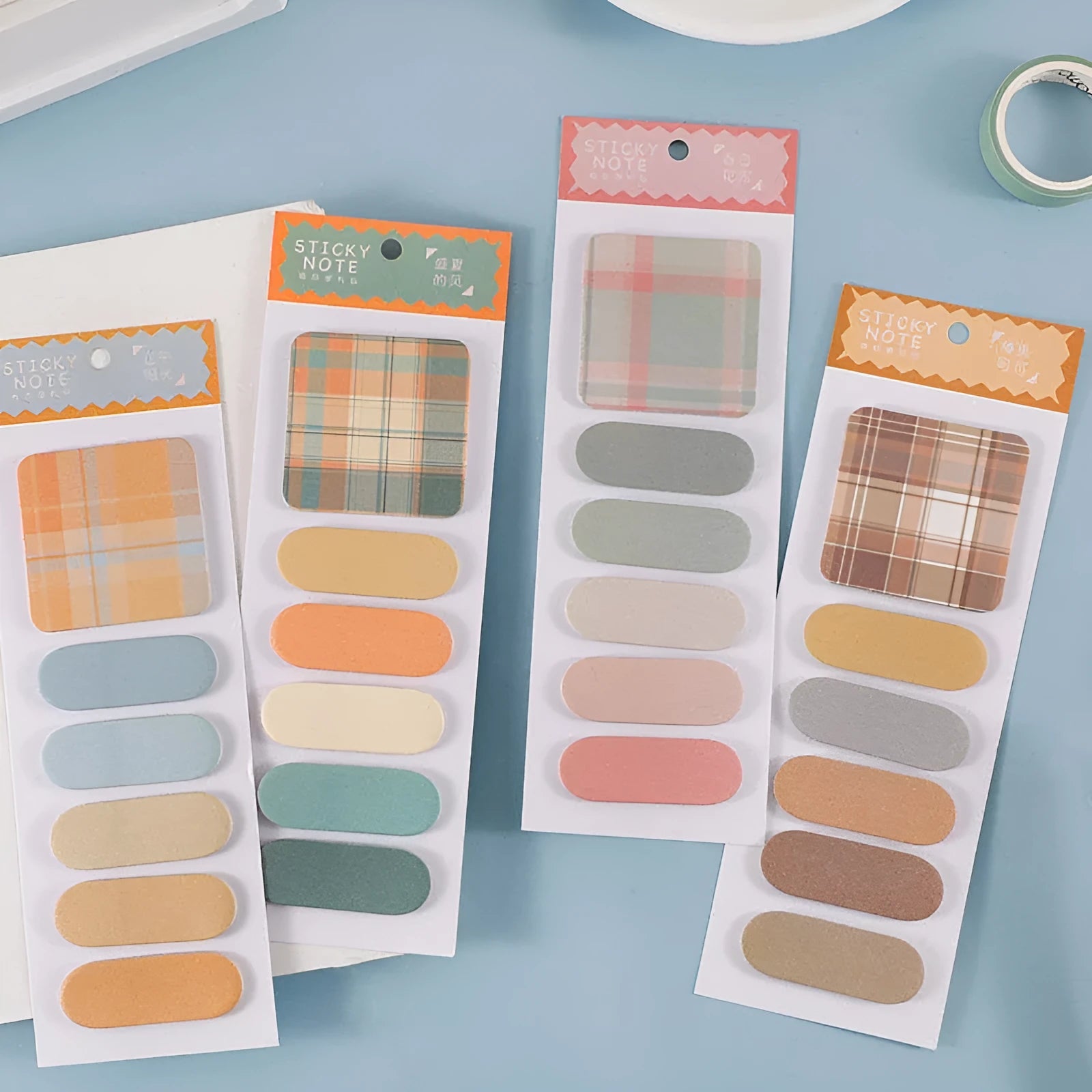 Colourful plaid sticky notes memo pad showing eight designs including Spring Garden and Blueberry Night.