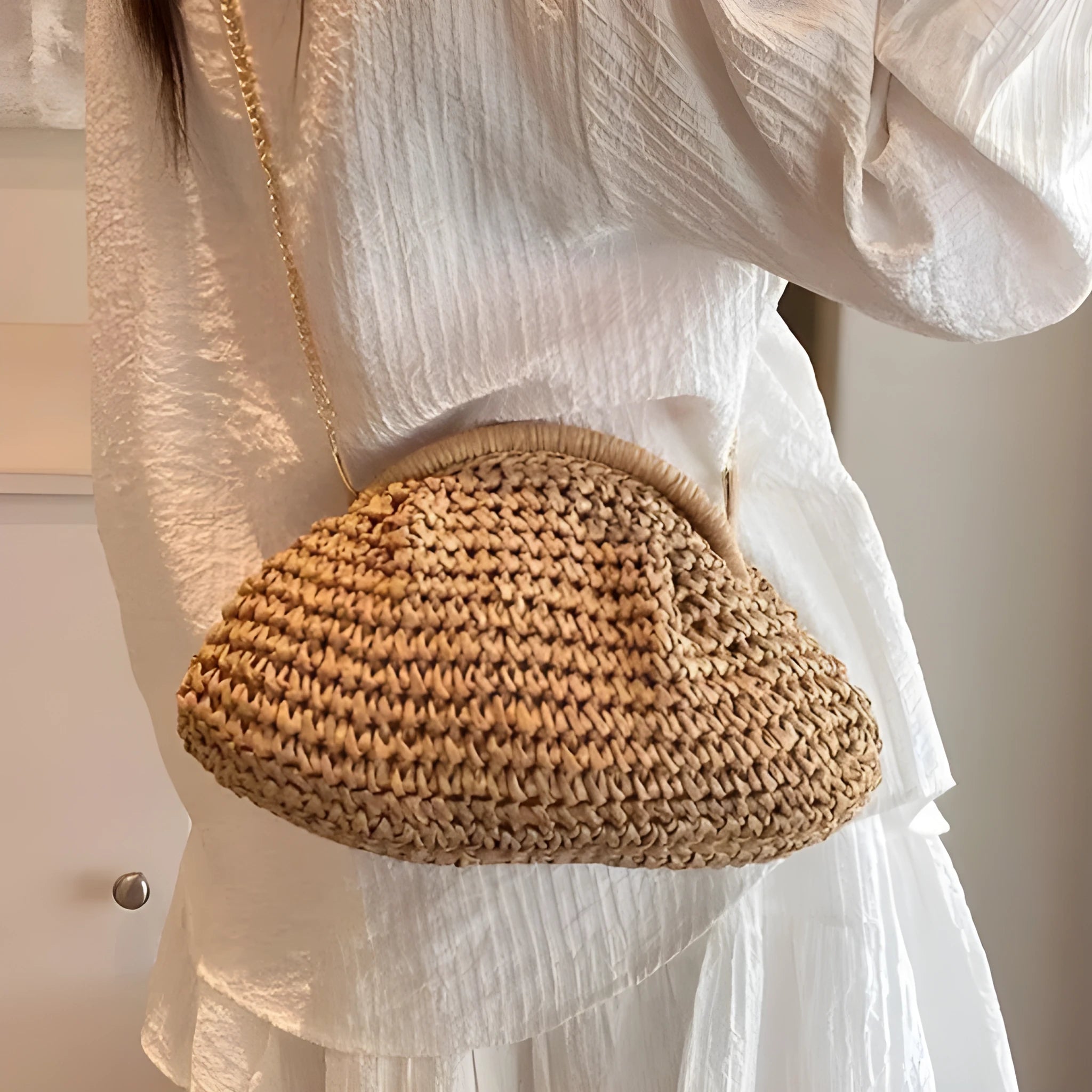 Women's beige shell-shaped paper straw bag with a metal chain strap.