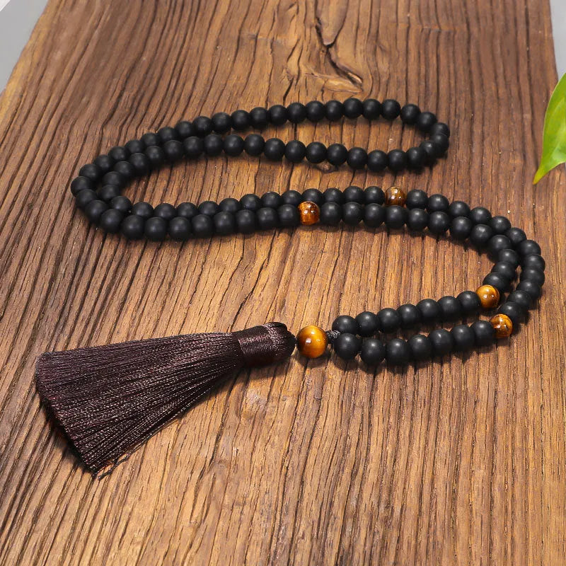 Tigereye stone drop pendant with tassel on long beaded necklace with matching bracelet.