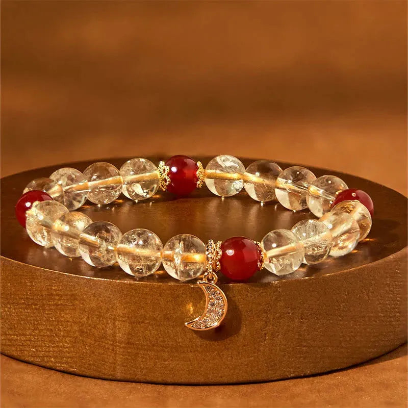 Women's crystal boom bracelet featuring citrine stone, red agate, and central moon design