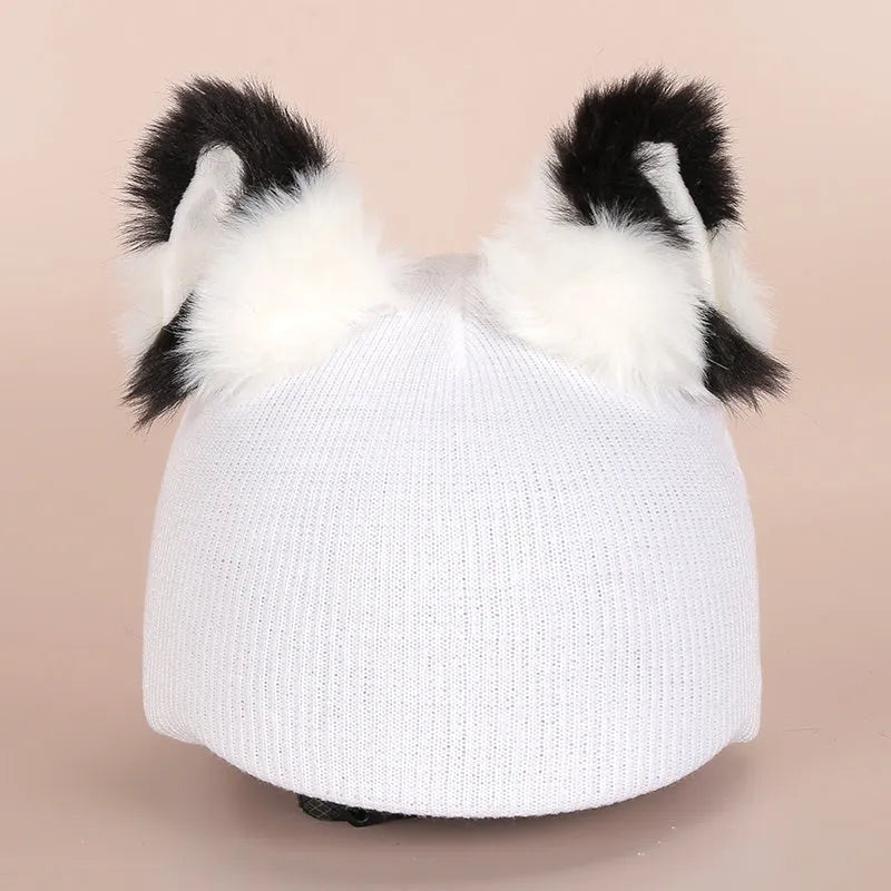 Plush cartoon-themed cover set on a medium motorcycle helmet with soft ear decorations.