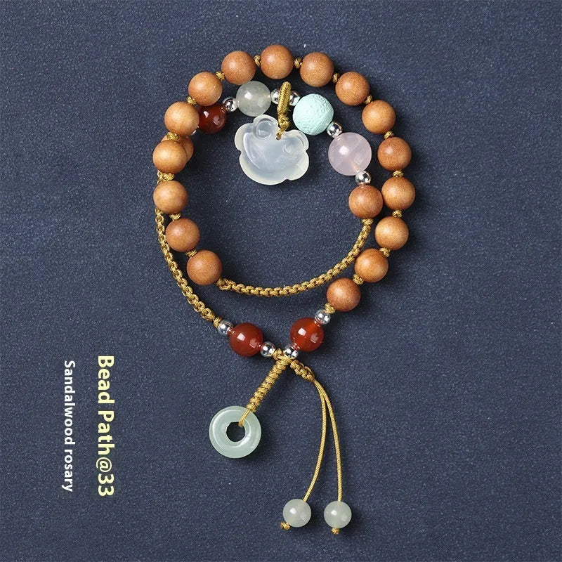 Hand-woven ebony bracelet with double ring design and traditional ruyi elements