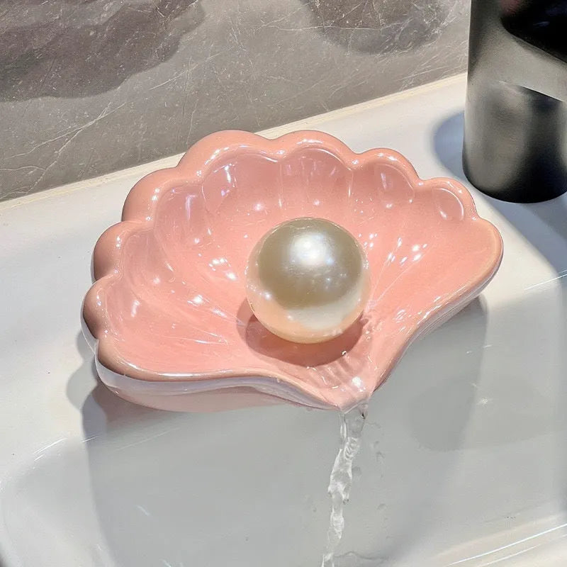 White and pink plastic shell-shaped soap dish for bathroom counter or shower