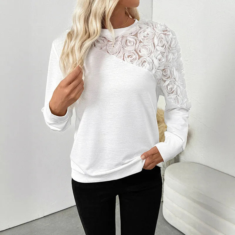 White floral print long sleeve women's pullover top with a loose fit.