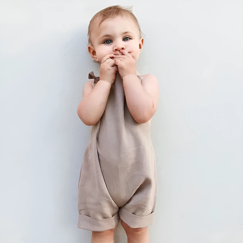 Children's khaki cotton overalls shorts with bow detail and straps, front view