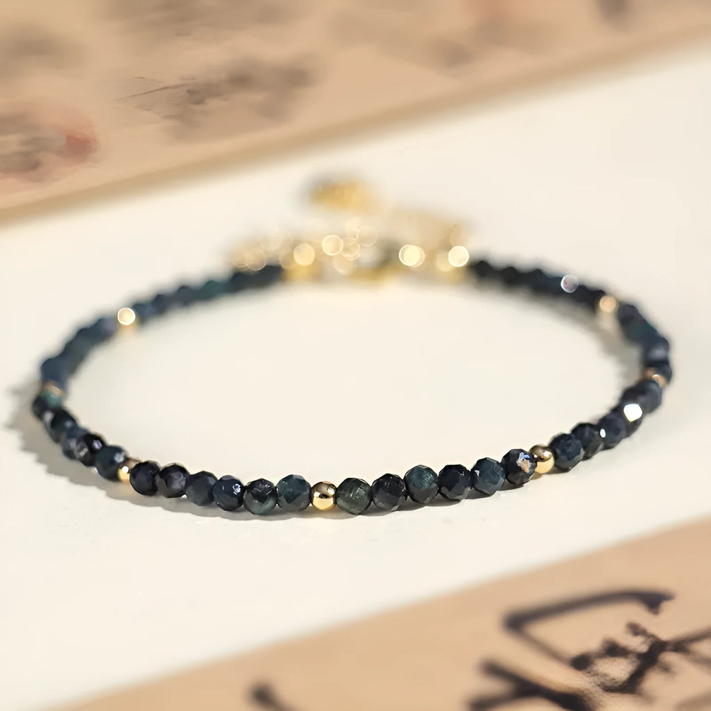 Blue tourmaline bracelet with 3mm beads and metal spacer sections on wrist