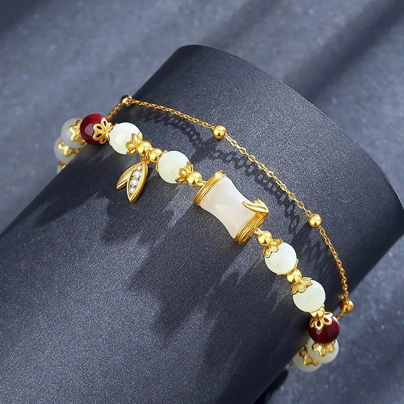 Bamboo style bracelet with electroplated coloured glass beads in a Ruyi flower design.
