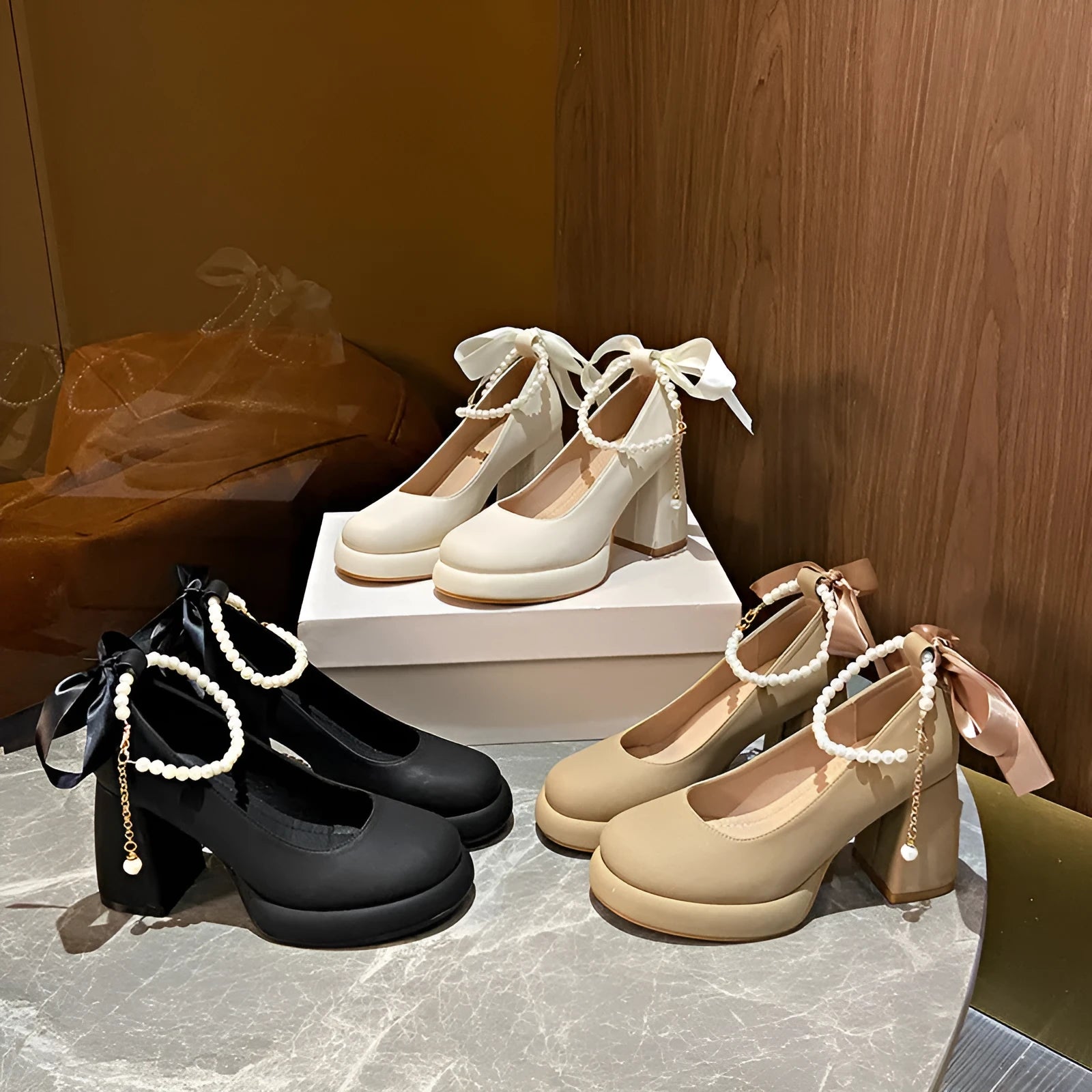 Women's beige Mary Jane shoes with a chunky heel and an adjustable ankle strap buckle.