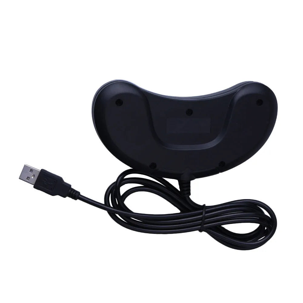 Black Sega USB wired PC game controller with 1.8-metre cable next to a computer.
