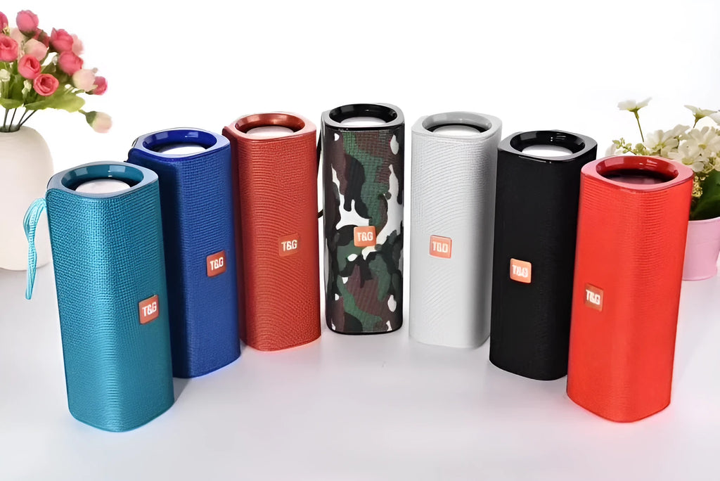 Cloth-covered portable Bluetooth speaker in multiple colours showing USB port and control buttons.