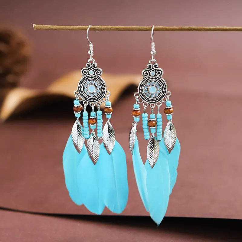 Feather earrings with round drop design in twelve bohemian colours including skin pink, light purple and mixed shades