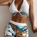 Women's solid colour white split top swimsuit with leaf print boxers bottoms, backless, sleeveless, polyester fabric
