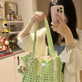 Handmade woven shoulder bag with a floral pattern, made from soft wool yarn.