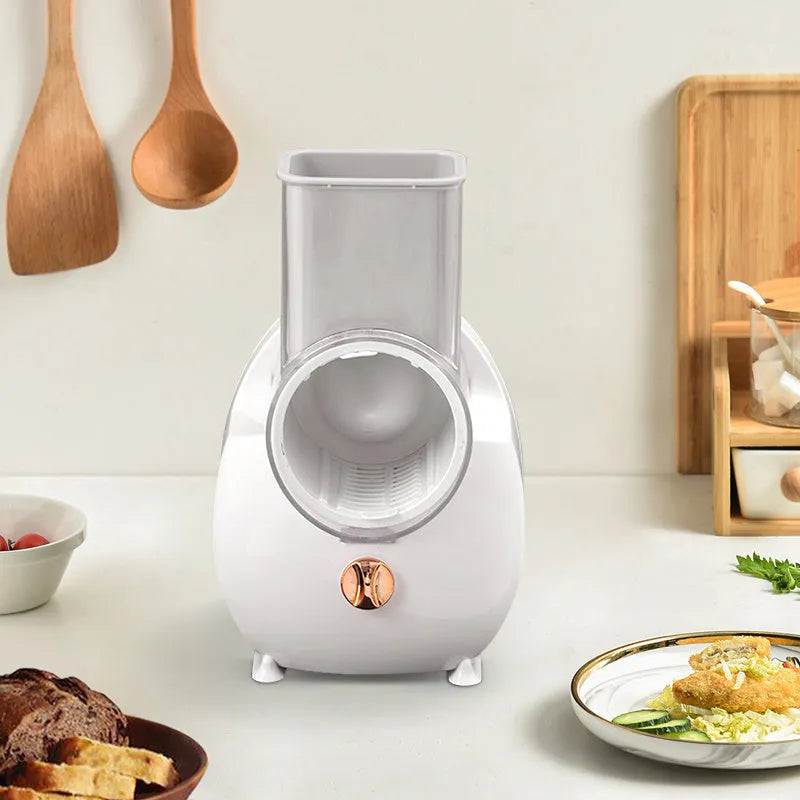 White electric vegetable slicer with rotary blades and suction base for kitchen food preparation