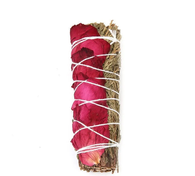 White sage and red rose petal colourful aromatherapy incense bundle on a wooden table