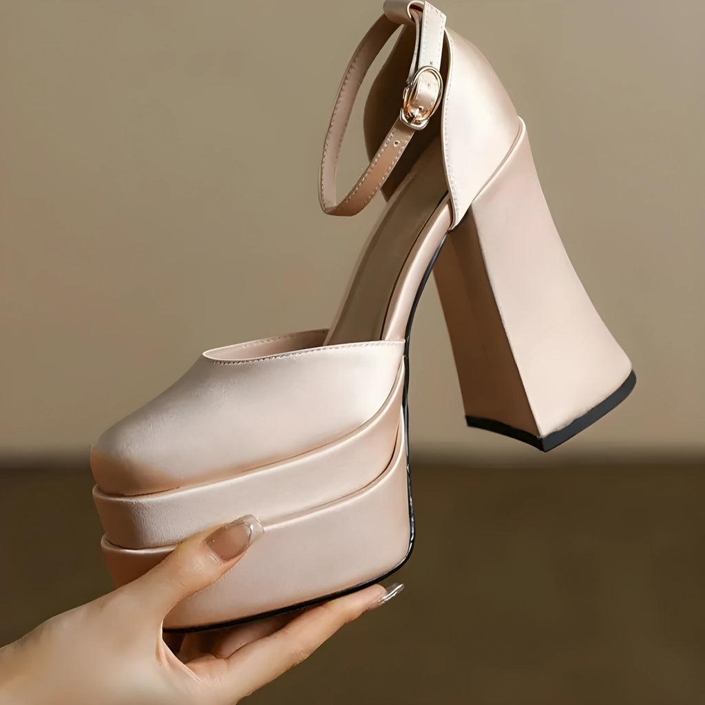 Women's white chunky heel platform pumps with a round toe and waterproof upper on a rubber sole.