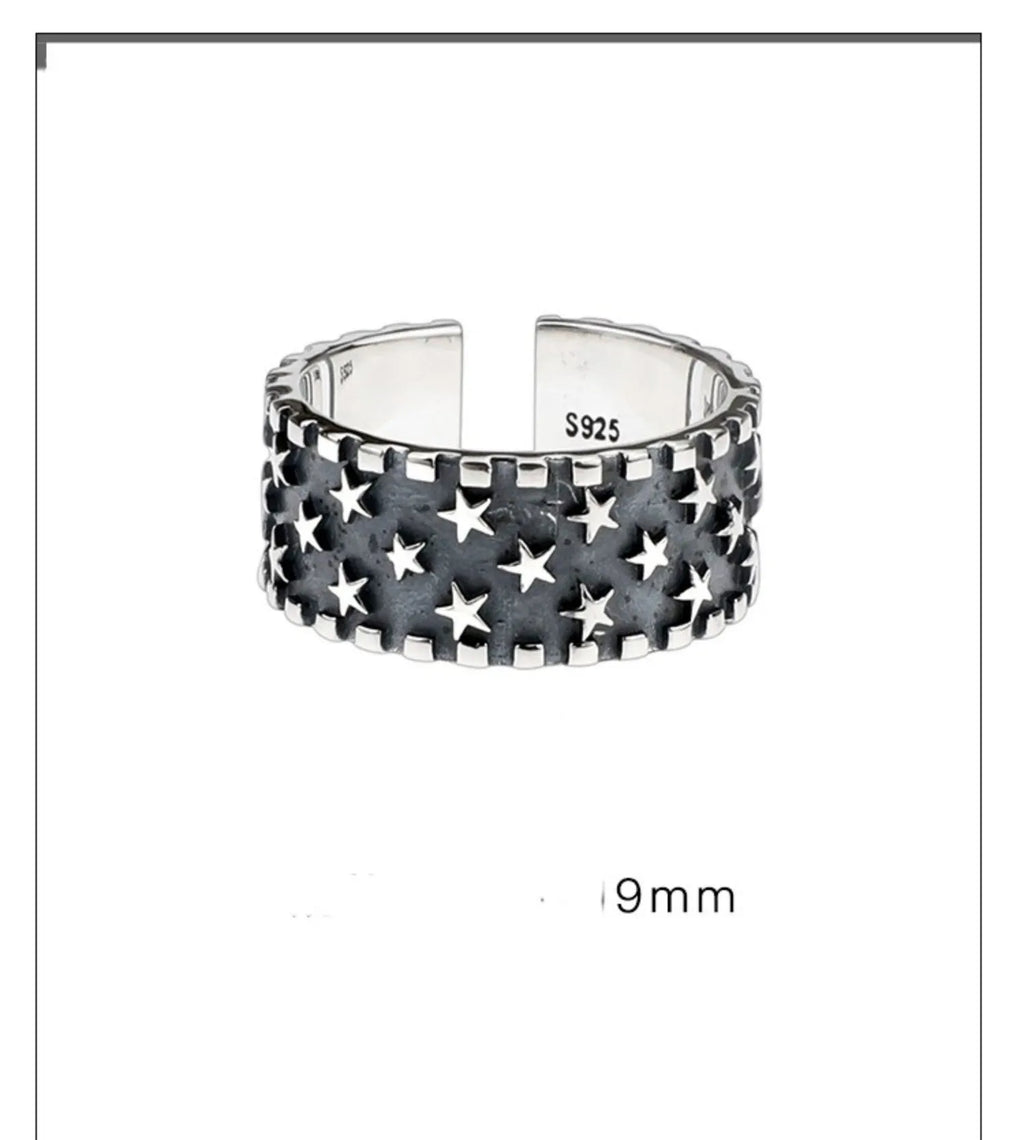 Sterling silver ring with geometric multi star pattern and adjustable opening.