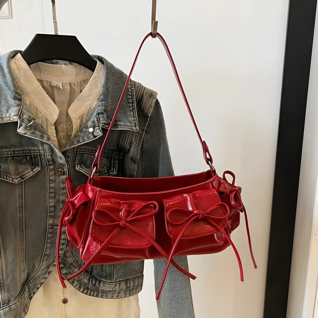 Women's shoulder bag with tassel bow decoration and multi-pocket design in various colour options