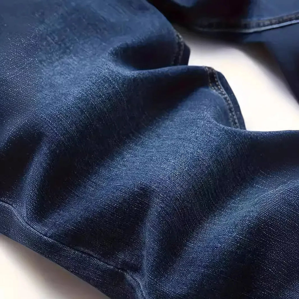 Men's dark blue slim fit casual jeans with a mid-waist and skinny leg style.