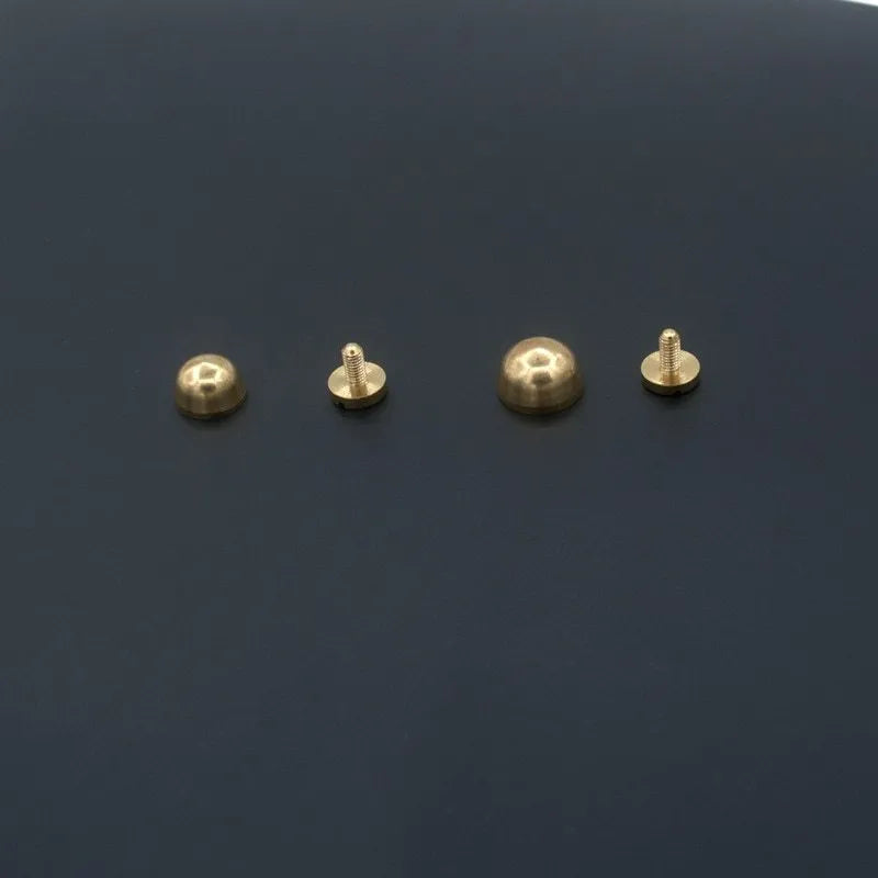 Assortment of brass decorative buckles in antique gold finish showing round foot nail and bucket foot nail designs