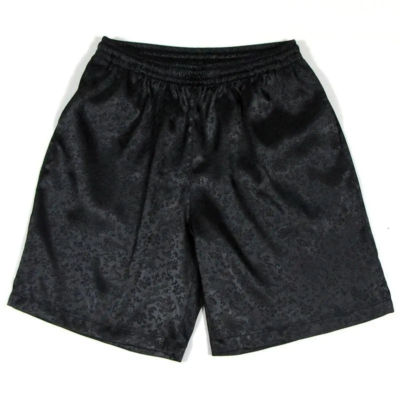 Man wearing black Tang Suit-style Tai Chi shorts with an elastic drawstring waistband.