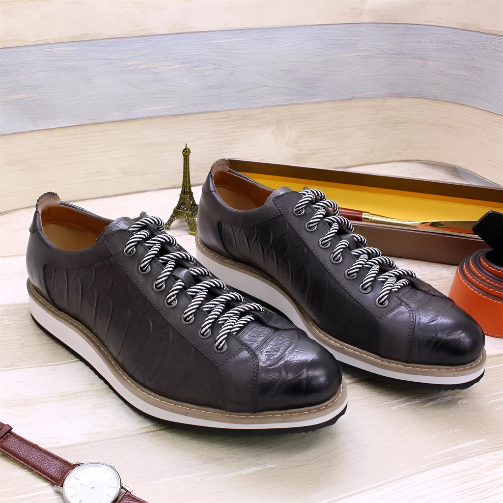 Men's low top handmade shoes with an embossed pattern, shown with front tie laces.