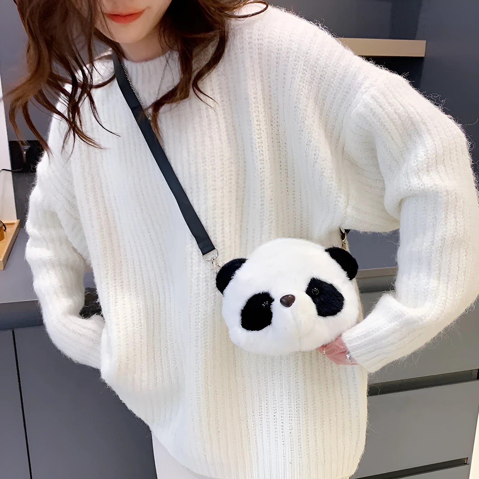 Soft plush panda head crossbody bag with cylindrical shape and sandwich pocket.