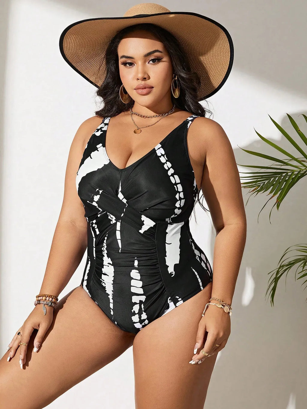 Black conservative one-piece swimsuit on a mannequin, showing sleeveless design and Siamese colour matching pattern.
