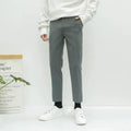 Men's straight-leg cotton trousers with drawstring waist in black, grey, and khaki colours