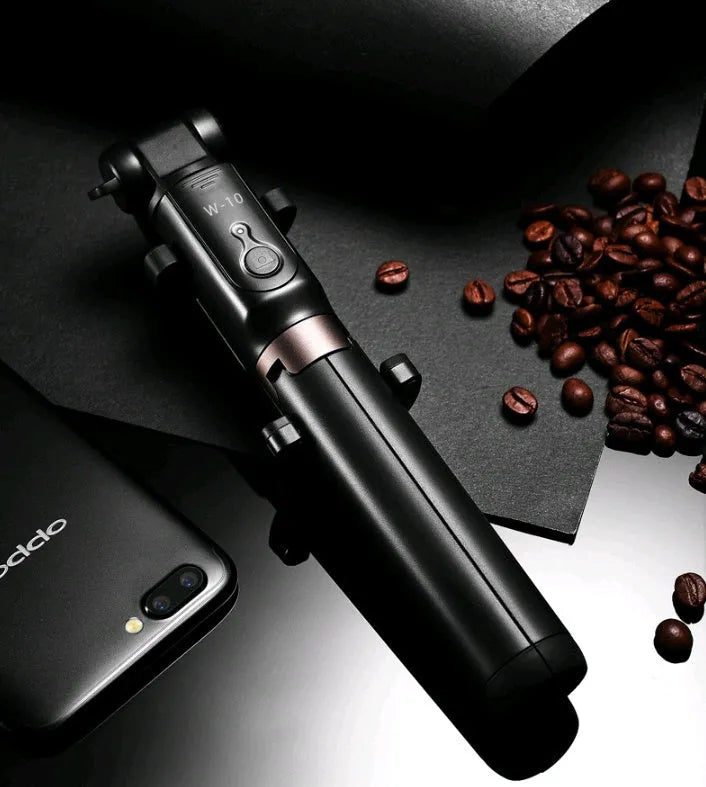 Aluminium alloy Bluetooth selfie stick with remote control and adjustable phone clip next to a smartphone