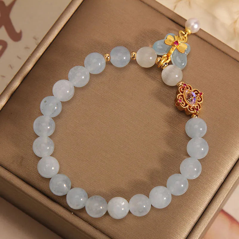 Aquamarine butterfly pendant crystal bracelet for women with rhinestone details on silver chain.