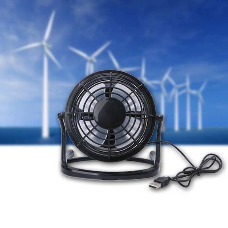 Mini portable USB desk fan with adjustable angle in black colour beside laptop