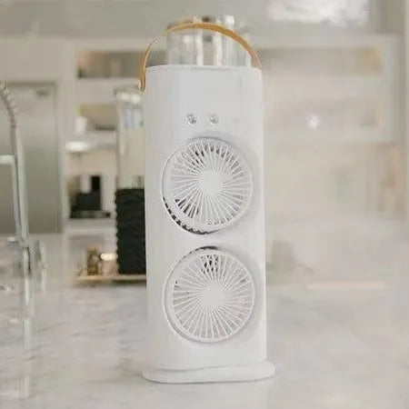White portable humidifier fan with two spray heads, remote control, and coloured LED lights on a desk.