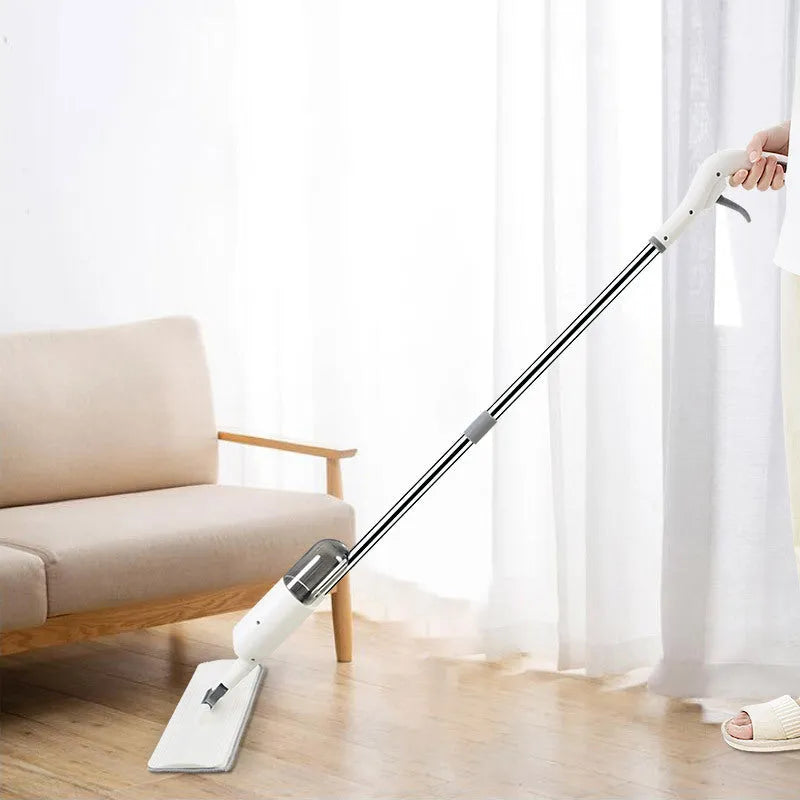 Flat cleaning mop with blue microfiber pad next to a white wringing bucket.