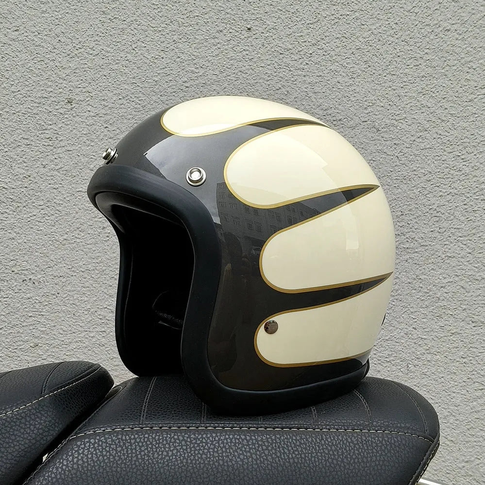 Retro-style open face motorcycle helmet in fibreglass, shown in a selection of colours including cement grey and matte black.