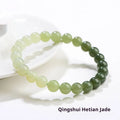 Natural clear water Hetian jade bracelet showing gradient colour on round beads and barrel beads.