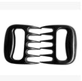 Two black bear claw meat shredding forks for barbecue preparation on kitchen surface
