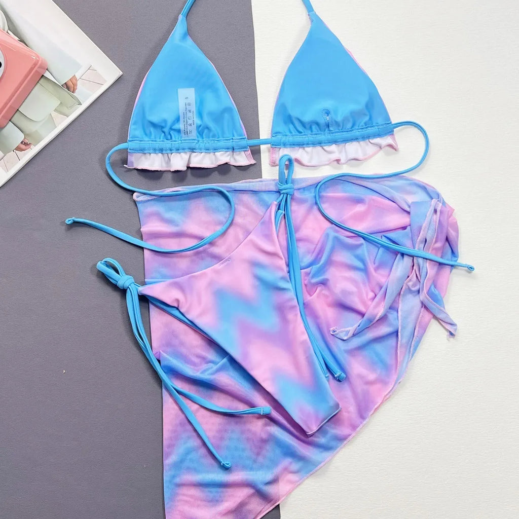 Women's tie-dye patterned bikini swimsuit set with bra, panties, and skirt.