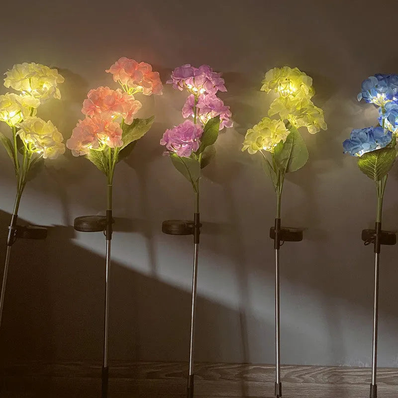 Solar hydrangea garden lights with plant-shaped design and floor outlet base in outdoor setting
