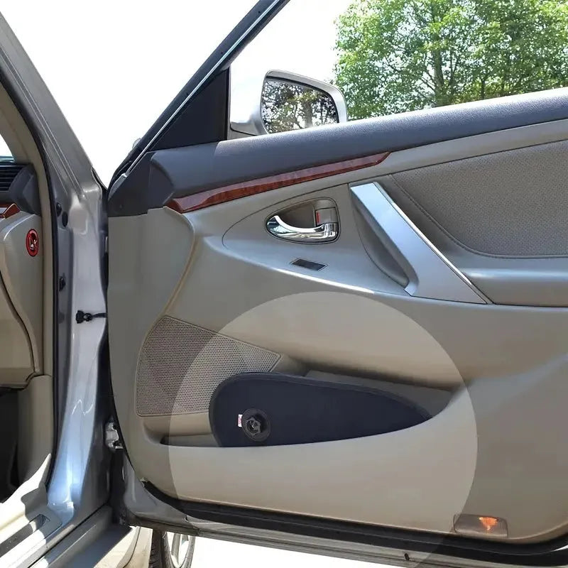 Black stretchy car window shade with suction cups attached to a car side window.