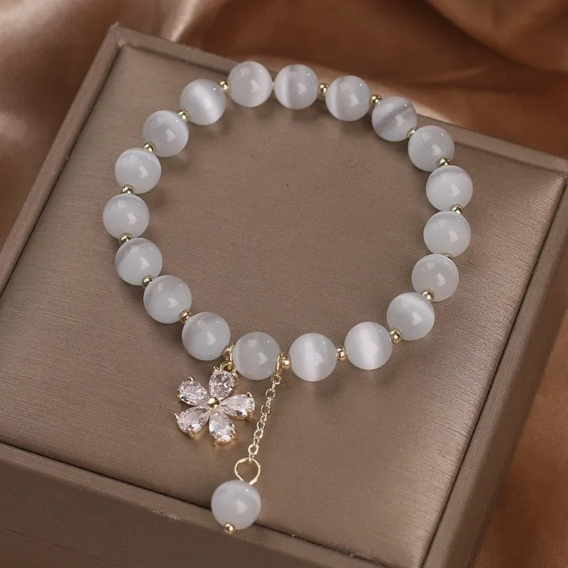 Women's white cat's eye crystal bracelet with floral tassel and morganite safety buckle pendant