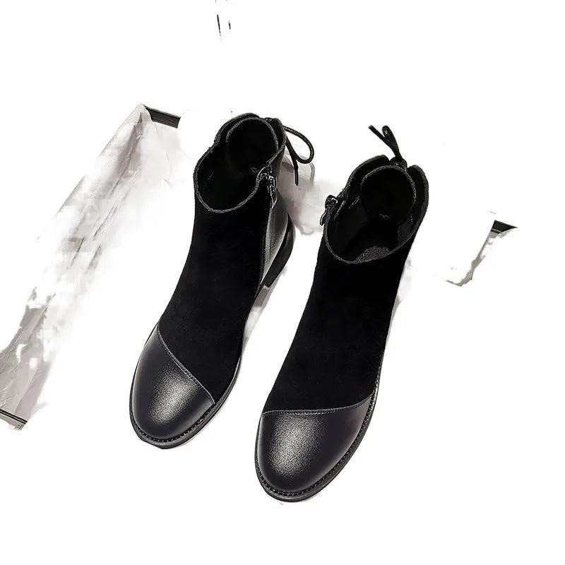 Women's black Martin boots with side zipper, non-slip rubber soles, and decorative bow detailing