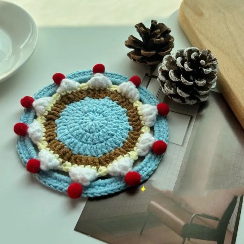 Handmade round wool coaster bag for hot mugs on a table