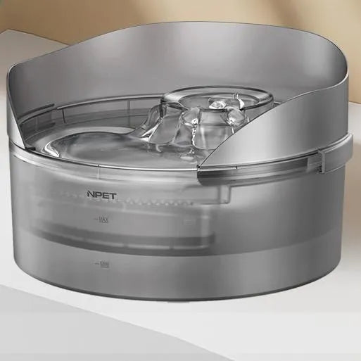 White automatic pet water fountain with flowing stream on a kitchen floor.