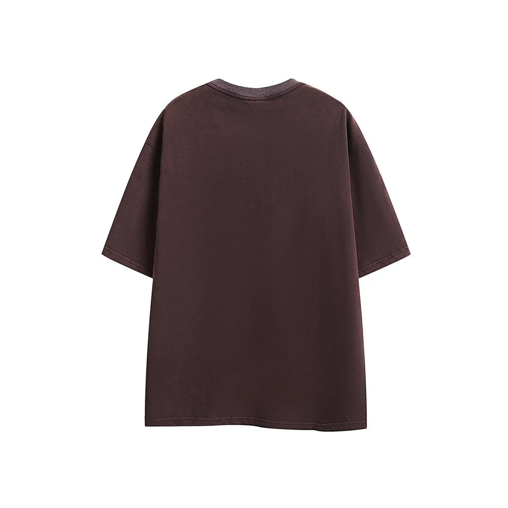Purple loose-fit short-sleeved cotton t-shirt featuring an embroidered retro pattern on the chest.