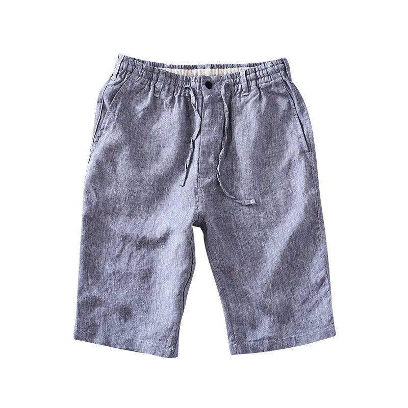 Men's loose-fit linen capri trousers in a straight leg style on a hanger.