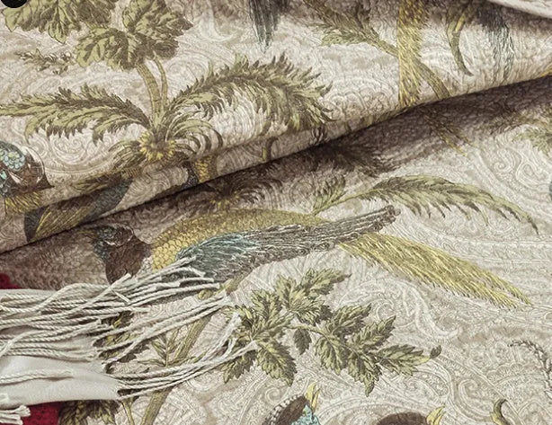Blue American floral and bird pattern quilted cotton bedspread set laid on a bed.