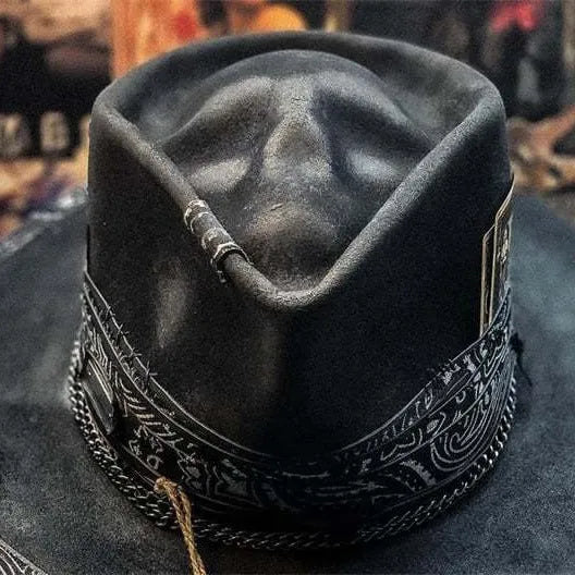 Handmade wool felt Halloween hat with a conical crown in a skull design.