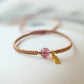 Adjustable red rope bracelet with sliding strawberry quartz bead in national tide style.