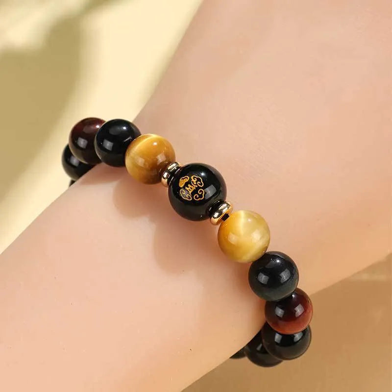 Manually crafted black agate beaded bracelet with gold, blue, and red tiger eye stones, showing ethnic zodiac design.